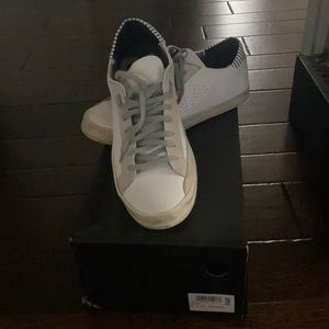 P448 white leather sneaker with gray stripe detail on heal tag.